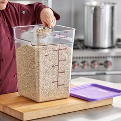 a woman in a red shirt is measuring ingredients into a container on a cutting board