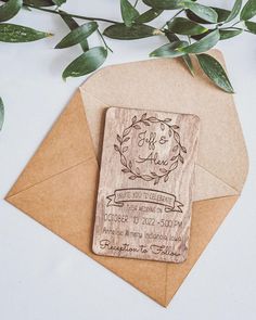 an envelope with a rubber stamp on it next to some green leaves and a plant