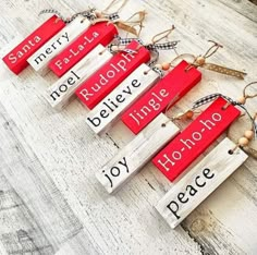 small wooden signs with words written on them hanging from twine string and wood planks