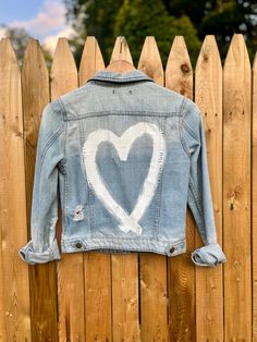 a denim jacket with a heart painted on it