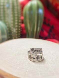 "Western style metal stamped ring with Saguaro cactus and diamond shapes. Inspired by the southwest.   Sizing: You will be able to select your size when purchasing. For help finding your size Google \"how to find your ring size\". These rings are somewhat adjustable, select sizing available because it's a wrap ring.  Please note: Each ring is handmade to order.  Estimated time to make the ring and ship: 3-5 business days. Care and maintenance: To keep ring looking its best, I recommend removing Western Ring, Cactus Ring, Rodeo Jewelry, Western Rings, Ring Wrap, Stamped Ring, Stamped Rings, Black Sharpie, Saguaro Cactus