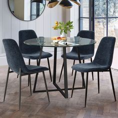 a glass table with four chairs around it