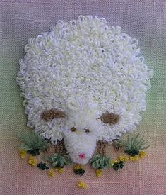 a sheep made out of crocheted yarn and flowers