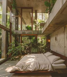 a bed sitting in the middle of a bedroom next to a wooden wall with plants growing on it