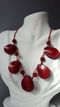 Tagua nuts make this African beaded necklace a versatile piece that works with most outfits. length: 8.5 inches when worn. *Ready to ship *Handmade *Eco friendly Please note that this is a handmade product, and the color pattern of the tagua nuts will differ for each necklace Your finished necklace is similar, but not exactly identical. Also, the color of the photo images may differ slightly due to variations in computer resolution. Images may also appear larger. Tagua nuts, also known as vegeta Casual Large Beaded Necklace For Festivals, Casual Large Beads Necklace For Festival, Wooden Beads For Festival, Artisan Shell Necklace Gift, Red Fair Trade Necklace As Gift, Red Fair Trade Beaded Necklace As Gift, Casual Wooden Beads Necklace As Gift, Casual Wooden Beads Necklace For Gift, Adjustable Round Beads Shell Necklace