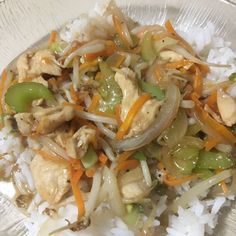 a white plate topped with rice and meat covered in sauce, bell peppers and onions