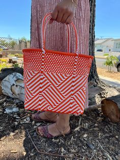 "This beautiful hand-woven, small tote is the latest creation of my business parter Cupertino. Handcrafted in Mexico. 9 1/2\"L x 9 1/2\"H x 5\"D; 16\" H with straps." Summer Orange Woven Shoulder Bag, Casual Orange Woven Shoulder Bag, White Woven Basket Shoulder Bag, White Handwoven Square Shoulder Bag, White Handwoven Rectangular Shoulder Bag, White Woven Shoulder Bag With Double Handle, Casual White Handwoven Shoulder Bag, White Handwoven Basket Shoulder Bag, Summer Handwoven Orange Shoulder Bag