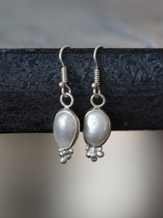 This is a set of lovely sterling silver and freshwater pearl dangle earrings, embellished with small fine silver spheres. The pearls were set  in hand- made fine silver bezels and the earrings were fitted with custom made earhooks. They are really pretty, super comfortable and have a great size for everyday wear. Measurements: Earring: 25mm high (with hook 39mm), 9mm wide weight 2g/earring Packaging: all mazulou items are shipped in a beautiful gift box Process: Fine silver bezels were formed to Pearl Earrings Dangle Silver, Elegant Sterling Silver Nickel-free Pearl Earrings, Elegant Sterling Silver Pearl Earrings Nickel Free, Formal Sterling Silver Pearl Earrings Nickel Free, Formal Sterling Silver Nickel-free Pearl Earrings, Dainty Sterling Silver Drop Bridal Earrings, Silver Sterling Silver Pearl Earrings For Wedding, Elegant Nickel-free Sterling Silver Bridal Earrings, Formal Silver Sterling Silver Pearl Earrings