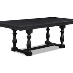 a black table with wooden legs and an ornate design on the top, against a white background