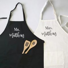 two personalized aprons with wooden utensils on them, one for mr and mrs