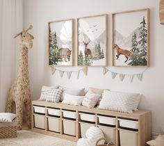 a room with some animals on the wall and pictures hanging above it, along with storage bins