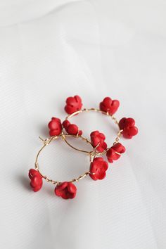 Feel like the beautiful and effortless goddess you ARE while wearing our Poppy Hoop in Cherry Red! Entirely handcrafted with love from start to finish in our Rose and Clay studio, these lightweight, girly hoops boast a delicate 16k gold filled hoop and wire, the most perfect shade of cherry red, and hand sculpted clay flowers. These earrings just scream: romantic and feminine style (and we are OBSESSED with that). Ideal for year round wear, these dainty and tarnish proof hoops will absolutely ne Red Hoop Jewelry For Wedding, Handmade Red Hoop Earrings For Wedding, Handmade Hoop Earrings For Valentine's Day, Clay Studio, Gold Filled Hoops, Sculpting Clay, Clay Flowers, Cherry Red, Buying Jewelry