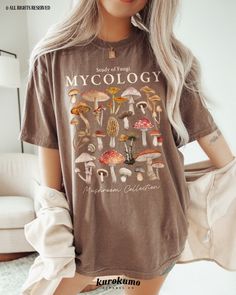 This Unisex garment-dyed t-shirt features "Study of Fungi | Mycology | Mushroom Collection" with a lovely set of watercolor mushroom illustrations. It is the perfect gift for present / future mycologists, science teachers, mushroom foragers & more! Make sure to check out the other garment options below :) » O P T I O N S « ‣ Crewneck: https://www.etsy.com/listing/1700683435 » A B O U T « ‣ This item is made to order using direct-to-garment (DTG) printing technology. This digital process involves Clothes Mushroom, Mushroom Outfit, Mushroom Illustrations, Girl Camping, Watercolor Mushroom, Mushroom Cottagecore, Camping Clothes, Science Gifts, Camping Outfits