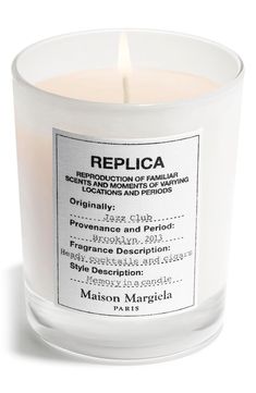 a candle that is sitting on top of a white surface with the words replicaa printed on it