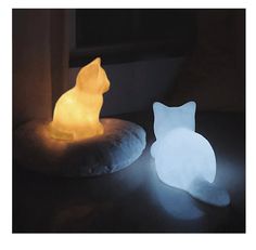 a cat shaped light sitting on top of a pillow