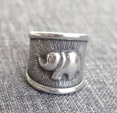 "Handmade Sterling Silver Elephant Band Cuff Ring, Adjustable Open Ring, can be used as Thumb ring Width: 0.9\" / 2.3cm Symbolism of Elephant: Elephant is an important symbol in Buddhism and Hinduism. The main characteristics of the elephant are strength and steadfastness. There for it symbolizes physical and mental strength, as well as responsibility and earthiness. In Buddhism the elephant is a symbol of Mental strength. With the practice of dharma and taming one's mind, the mind which becomin Adjustable Metal Wide Band Ring, Elephant Ring, Boho Handmade, Silver Elephants, Thumb Ring, Cuff Rings, Thumb Rings, Handmade Boho, Open Ring