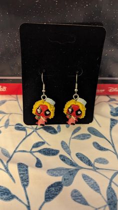 These are Funko Bitty Pops turned into earrings.  They still fit in their box and can be worn with or without the base on them.    (the base does have a very tiny screw that holds it on the Bitty Pop!. They weigh approximately 2 grams each without the base and 3 grams with the base.  Each purchase is for 1 pair.  Matching Characters. Themed Red Earrings, Themed Dangle Earrings, Themed Dangle Pierced Earrings, Themed Earrings For Pierced Ears As Gift, Themed Pierced Earrings As A Gift, Themed Gift Earrings, Themed Dangle Earrings For Gifts, Themed Dangle Earrings As Gift, Themed Drop Earrings For Gifts