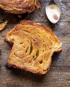 two pieces of bread sitting on top of a wooden table