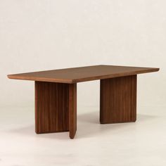 a wooden table sitting on top of a white floor