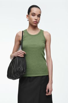 Made from ribbed organic-cotton jersey with a touch of stretch, this slim-fit tank top is an essential on warmer days. It's offered in a fresh green hue that will brighten up neutral outfits and has endless styling opportunities – wear it alone or layered under shirts and blazers.  Round neckSleevelessOrganic cotton is grown from non-genetically modified seeds without chemical fertilizers or pesticides  Shell: 97% Organic cotton, 3% Elastane. Excluding trims / Machine washable Back length of siz Neutral Outfits, Ribbed Tank Top, Cowl Neck Top, Neutral Outfit, Ribbed Tank Tops, Ribbed Tank, Grey And Beige, Pesticides, Workout Tank Tops