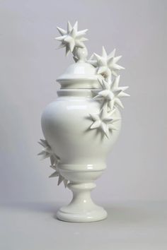 a white vase with star decorations on it