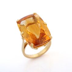 Big citrine cocktail ring in 18K gold is a perfect statement jewelry to match with every outfit of your wardrobe. It's just a simple ring and simplicity is the ultimate form of sophistication.  Citrine purges out the negative energies from our surroundings and also relationships.  Designed with prong set oval cut citrine statement solitaire ring that makes it a perfect fit to wear it on your wedding or style it with any of your basic outfit to give it a glam.  PRODUCT DETAILS :-  > Material - 18 Orange Sapphire Ring For Formal Occasions, Modern Citrine Rings For Formal Occasions, Modern Yellow Topaz Ring For Anniversary, Modern Yellow Gold Topaz Ring With Polished Finish, Modern Yellow Topaz Anniversary Ring, Elegant Orange Yellow Sapphire Rings, Formal Yellow Sapphire Ring With Ethical Gemstones, Timeless Yellow Gold Topaz Ring With Polished Finish, Formal Yellow Gold Topaz Ring With Polished Finish