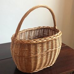 a wicker basket sitting on top of a wooden table