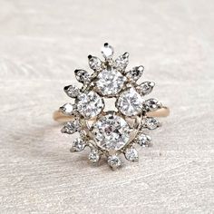 "Antique Diamond Cluster Ring 14K Yellow and White Gold Art Deco 1.59 CTW Old European & Round Brilliant! GIA G.G. Appraisal Incl 6,260 Usd! This amaaaazing ring will be cherised by the vintage loving woman who likes to make a statement! The crown is large and measures approximately mm x mm, forming a pear shaped cluster, and rises mm from the finger. It has a WOW presence on the hand, beautiful without being gaudy. The largest diamond is .60 carat, SI1 clarity and G color and is an old european Luxury Pear-shaped Diamond Ring With 17 Jewels, White Marquise Diamond Ring With 17 Jewels, Luxury 14k White Gold Diamond Ring With 17 Jewels, Dazzling Pear-shaped Ring With Rose Cut Diamonds, Dazzling Pear-shaped Rose Cut Diamond Rings, Heirloom Cluster Ring In Diamond White, Yellow Gold Cluster Ring With 17 Jewels, Luxury Pear-shaped Brilliant Cut Cluster Ring, Heirloom White Cluster Ring