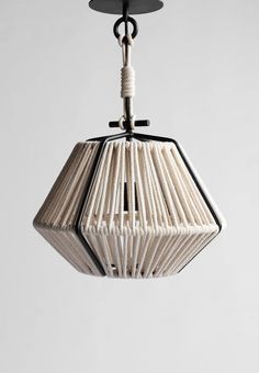 a white light hanging from the ceiling with black metal frame and wood strips on it