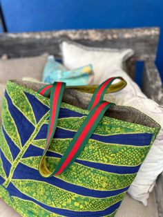 Extra large beach tote from my unique quilted and pieced design, including upholstery fabrics, quilted and lined with sunbrella canvas.  Velvet lined handles for comfort and pop of lime green color.  Scotch guarded three times, making the inetrior and exterior water resistant.  Solid and will last a life-time.  14" x 14" x 6" Zippered interior pocket for valuables. Quilted Green Shoulder Bag For Travel, Green Quilted Shoulder Bag For Travel, Green Quilted Rectangular Bag, Green Quilted Bag For Daily Use, Green Quilted Shopping Bag, Green Quilted Tote Shoulder Bag, Upholstery Fabrics, Beach Tote, Life Time