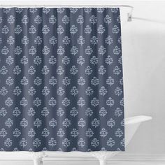 a blue shower curtain with an ornate design on the front and back side, hanging in a white bathtub