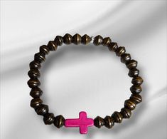 Brown wood stretchy bracelet embellished with hot pink dyed turquoise sideways cross. This would make a great gift for any occasion and a perfect secret sis gift. 7  inches stretchy If you do not see your size available you can still place order just send me a note during checkout and I will send right size. Comes gift ready! Adjustable Pink Cross Bracelet, Pink Adjustable Cross-shaped Bracelets, Dark Pink Color, Turquoise Cross, Bracelets Handmade Beaded, Cross Bracelet, Stretchy Bracelets, Brown Wood, Wood Beads