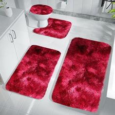 red bathroom rugs and toilet covers in a white bathroom