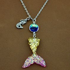 ♦ DESCRIPTION ♦ your Scale Color from a drop down menu. Mermaid Tail :33x41mm Scales: 12mm Chain measures about 22in Package: 1 Pcs The keychain packaged by OPP bag . Mermaid Tail Color: Pink blue blue &Pink Gold& Pink Purple&blue light purple Color of Scale(scales are 12mm) A:Clear B:light purple C:seaweed green D:Golden yellow E:ocean blue F:pink G:blue H:purple I:Silver gray J:Black K:blue purple L:Coffee Gold M:White All our items are NICKEL FREE and LEAD FREE. If you need more q Novelty Pink Jewelry With Lobster Clasp, Novelty Necklace With Lobster Clasp For Gift, Pink Novelty Jewelry With Lobster Clasp, Adjustable Charm Necklaces With Lobster Clasp For Party, Adjustable Party Charm Necklaces With Lobster Clasp, Adjustable Necklace With Lobster Clasp For Birthday Gift, Cute Silver Charm Necklaces For Party, Themed Gold Jewelry For Party, Themed Silver Necklace For Birthday