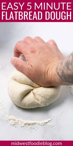 a hand is kneading an uncooked dough on top of a table