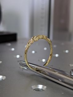 a gold ring sitting on top of a metal table