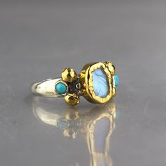 Moonstone Wedding Ring, Gold Moonstone Ring, Silver and Gold Ring, Mixed Metal Ring, Multistone Ring, Turquoise Ring, Wearable Art by yifatbareket on Etsy https://www.etsy.com/listing/290776705/moonstone-wedding-ring-gold-moonstone Moonstone Wedding Ring, Silver And Gold Ring, Mixed Metal Ring, Wedding Ring Gold, Gold Moonstone Ring, Mixed Metal Rings, Peridot Jewelry, Ring Turquoise, Garnet Jewelry