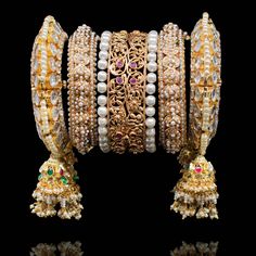 Adorn yourself in magnificence jewelry on your big day since you'll be looking nothing less than a queen! Exuding undeniable glamour, this bangle set features ornate filigree and enriched with beautiful stones for that ultimate sparkle. Gold-plated on high-quality brass as base metal. Made by order. Kindly allow 4-6 weeks for the delivery of this item. For custom or urgent requests, please contact support@alacouture.com. *Please Note: We use faux stones and beads in all of our jewelry. Temple Jewelry Bangle With Intricate Design, Ornate Diamond Jewelry With Intricate Design, Elegant Jeweled Bangle For Festivals, Elegant Jeweled Bangle For Festive Occasions, Elegant Hand Set Chandbali Bangle, Elegant Festive Bangle With Stone Work, Elegant Bangle With Intricate Design For Festive Season, Ornate Diamond Jewelry With Elegant Design, Elegant Festive Bangle With Intricate Design