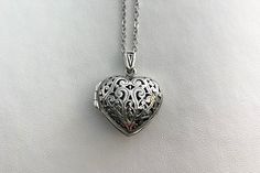 "BEAUTIFUL HEART shaped sterling silver locket for your photos or small mementos. The 20mm locket features an intricate open filigree design.  Includes an 18\" stainless steel chain with lobster claw clasp.  The locket opens from the side with a snap closure.  Arrives in an eco-friendly jewelry box, ready for gifting.   FREE SHIPPING Thank you for visiting my shop!" Elegant Filigree Heart Pendant Locket Necklace, Elegant Heart Pendant Locket Necklace With Filigree, Elegant Filigree Locket Necklace As A Gift, Elegant Heart Shaped Filigree Locket Necklace, Elegant Heart-shaped Engraved Locket Necklace, Anniversary Filigree Pendant Locket Necklace, Filigree Pendant Locket Necklace Keepsake, Filigree Locket Pendant Necklace For Keepsake, Filigree Pendant Locket Necklace For Keepsake