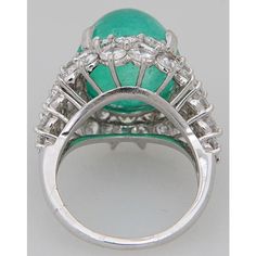 This spectacular 26c. Muzo Emerald is surrounded by 7.5c of beautiful diamonds mounted in platinum.  Size 8.5 US  The ring measures .92" wide by .92" tall by .65" deep. Oval Emerald Ring With Pave Setting In Platinum, Fine Jewelry Emerald Diamond Cabochon Ring, White Gold Diamond Ring With Cabochon, Anniversary Platinum Cabochon Ring, Platinum White Gold Rings With Cabochon, Luxury Silver Emerald Ring With Pave Setting, Luxury Emerald Cabochon Ring With Diamonds, Formal Emerald Cabochon Diamond Ring, Silver Cabochon Platinum Rings