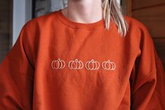 Hand embroidered pumpkin crew neck perfect for fall! Embroidered Crew Neck Sweater For Fall, Fall Embroidered Graphics Sweatshirt, Fall Sweatshirt With Embroidered Graphics, Fall Crew Neck Sweatshirt With Embroidered Logo, Casual Fall Sweater With Custom Embroidery, Embroidered Long Sleeve Sweatshirt For Fall, Orange Cotton Sweatshirt For Fall, Fall Crew Neck Sweatshirt With Custom Embroidery, Fall Long Sleeve Sweatshirt With Custom Embroidery