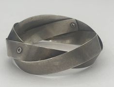 This is a very neat and unusual bracelet, it It's technically a bangle bracelet considering it goes all the way around but it looks a lot like a cuff. The bracelet is solid sterling silver and handmade. I do not see any markings but the bracelet has been tested and guaranteed to be sterling silver. It has a brutalist/modernist appearance to me. Very cool. Please see photos for approximate measurements. My wrist is a size 6 and it fits me perfectly. Clear Gift Bags, Cute Gift Boxes, Sterling Silver Bangle, Stylish Rings, Sterling Silver Bangles, Silver Bangle, Brass Jewelry, Silver Bangles, Metal Jewelry