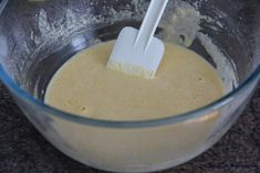 a blender filled with batter and two plastic spatulas