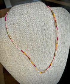 Seed bead necklace is approximately 16" long and finished with 18k gold filled findings. Gold Heishi Beads Jewelry With Colorful Beads, Gold Heishi Beaded Chain Jewelry, Gold Jewelry With Heishi Beads And Beaded Chain, Gold Jewelry With Colorful Heishi Beads, Bohemian Single Strand Gold Beads, Gold Heishi Beaded Necklaces, Adjustable Gold Heishi Beads Necklace, Gold Heishi Beads Necklace, Gold Beaded Choker With Colorful Beads