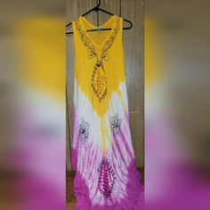 Bohemian Style. Handkerchief Hem. Sleeveless. Embroidered. Tie Dyed Bohemian Embroidered Sleeveless Sundress, Bohemian Embroidered Sleeveless Maxi Dress, Sleeveless Batik Print Maxi Dress For Summer, Bohemian Sleeveless Embroidered Maxi Dress, Yellow Sleeveless Sundress For Festival, Purple Sleeveless Bohemian Sundress, Bohemian Tie Dye Sleeveless Sundress, Sleeveless Embroidered Maxi Dress For Festival, Yellow Bohemian Dress With Batik Print