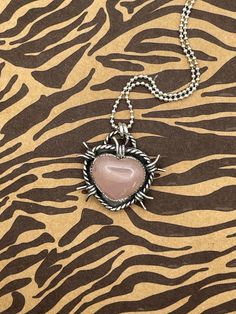 Barb Wire Rose Quartz Heart Pendant  Stone: Rose Quartz  Shape: Heart Stone  Origin: Brazil Carats: 12.75 CT  Metal: 925 Sterling Silver  Details: Serrated Bezel, Barb Wire Detail  Pendant Measurements: H 1.11 x W 1.23 inches  Chain Length: 18" inches Sterling Silver  One-of-a-Kind  Handmade in CA, USA Barb Wire Heart Jewelry, Wire Rose, Barb Wire, Heart Stone, Stone Rose, Rose Quartz Heart, Stone Heart, Stone Pendants, Sterling Silber