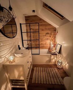 an attic bathroom with wooden walls and white fixtures, along with a rug on the floor