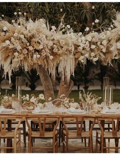 the table is set with flowers and candles