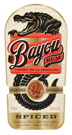 the label for bayou rum is shown in red and gold, with an alligator on it