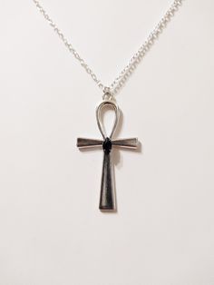 "◆ Pendant with Ankh cross The pendant measures 2.16535 x 1.1811 inches and it is silver plated, a beautiful black teardrop crystal is set in the center. the size of the chain is adjustable but for any need you can contact me :) The product is handmade with great care. ♡ In my shop there are many handmade jewels for all tastes, come and look at them you are welcome! ♡ -------------------------------------------------------------------------- The Ankh cross is perfect to wear around the neck and Black Symbolic Cross Pendant Necklace, Black Symbolic Cross Pendant Jewelry, Symbolic Black Cross Pendant Jewelry, Ankh Shaped Black Metal Necklace, Black Ankh Metal Jewelry, Black Ankh Necklace In Metal, Black Ankh Jewelry For Gifts, Black Metal Cross Jewelry, Black Cross Jewelry With Adjustable Chain